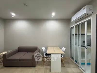 Modern living room with sofa and dining area in open layout apartment