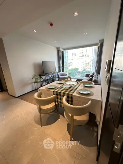 Modern living room with dining area and large window view in urban apartment