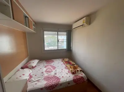 Cozy bedroom with air conditioning and floral bedding, perfect for relaxation.