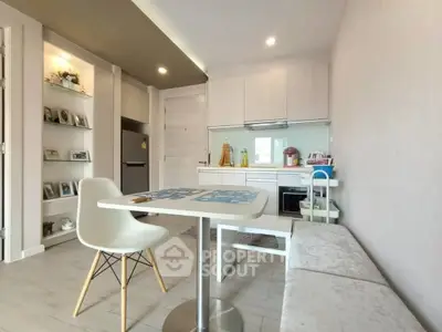 Modern kitchen with dining area and stylish decor in open layout apartment.