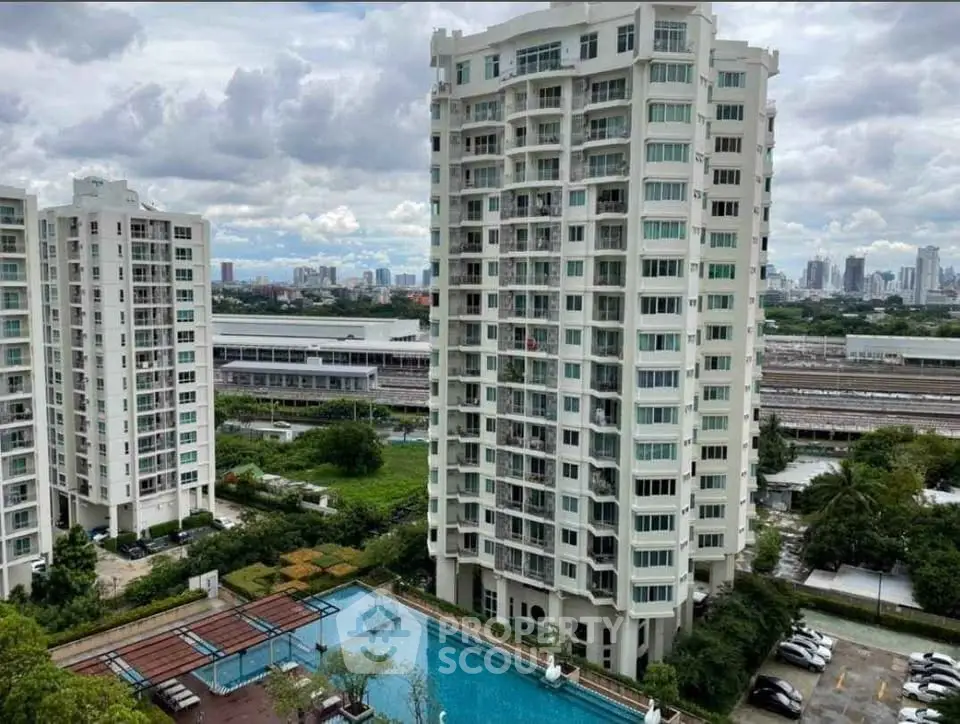 Stunning high-rise building with pool and cityscape view, perfect for urban living.