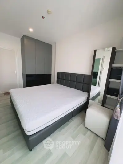 Spacious bedroom with modern king-sized bed, large wardrobe, and elegant flooring, perfect for restful nights and stylish living.