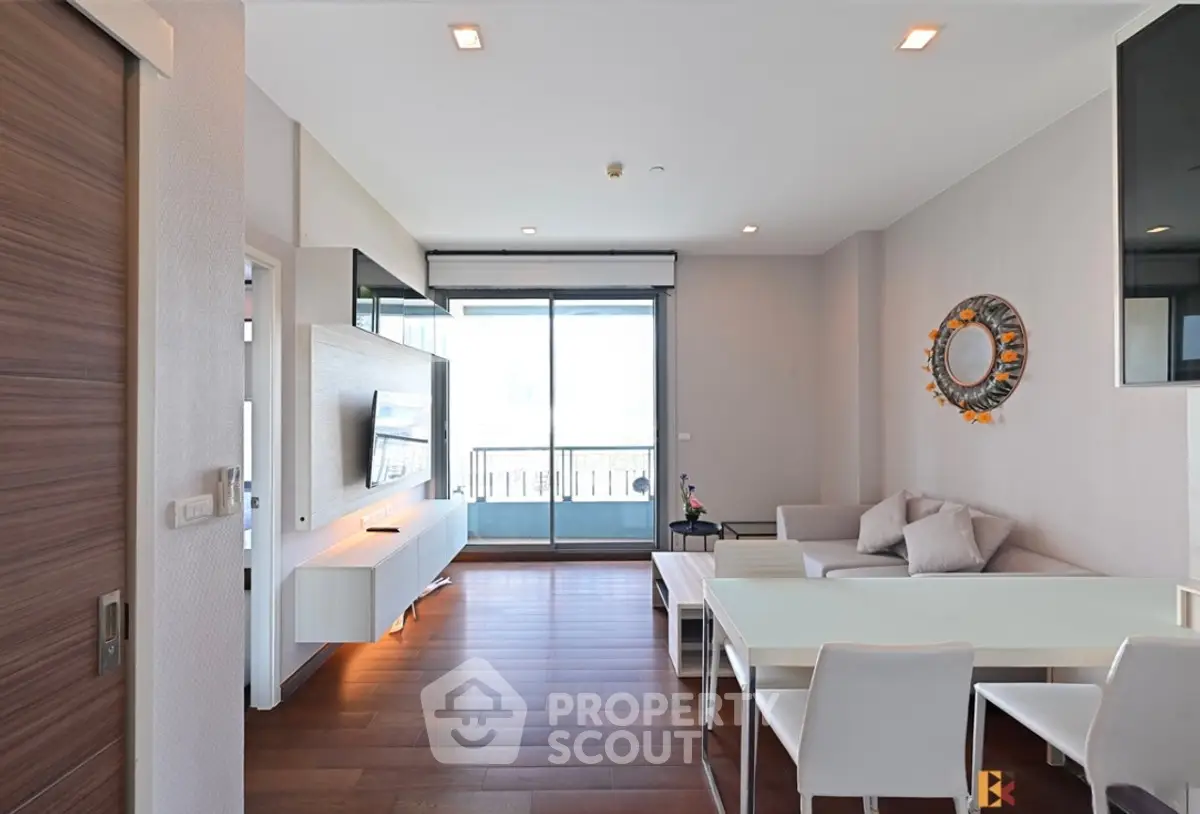 Modern living room with sleek furniture and balcony access