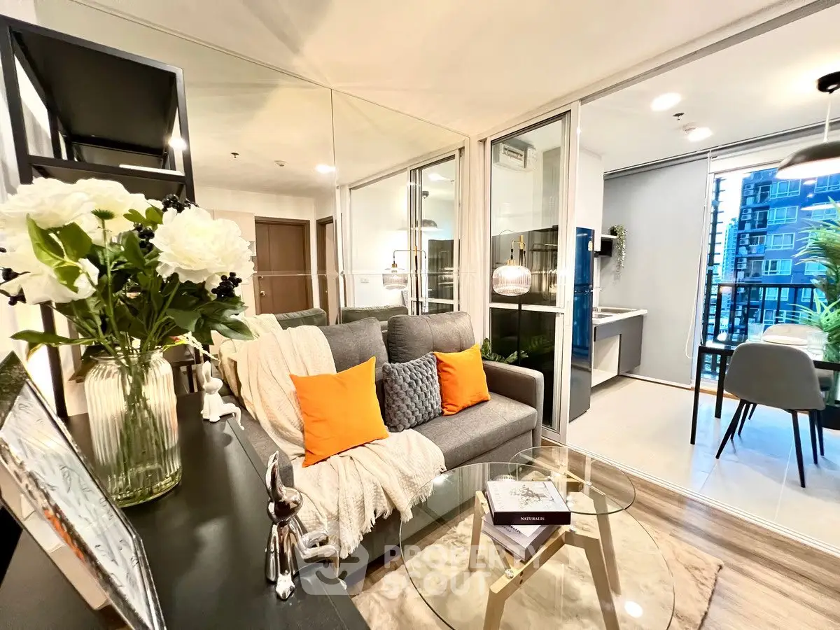 Modern living room with cozy seating and glass table, adjacent to dining area with city view.