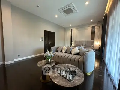 Luxurious bedroom with elegant decor and plush furnishings, featuring a cozy seating area and stylish lighting.