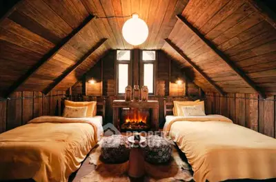Cozy rustic attic bedroom with twin beds and warm wooden decor