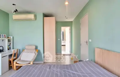 Spacious bedroom with modern decor and air conditioning in a stylish apartment.