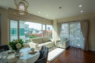 Spacious living room with large windows and elegant decor in modern apartment