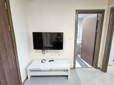 Modern living room with wall-mounted TV and sleek white furniture