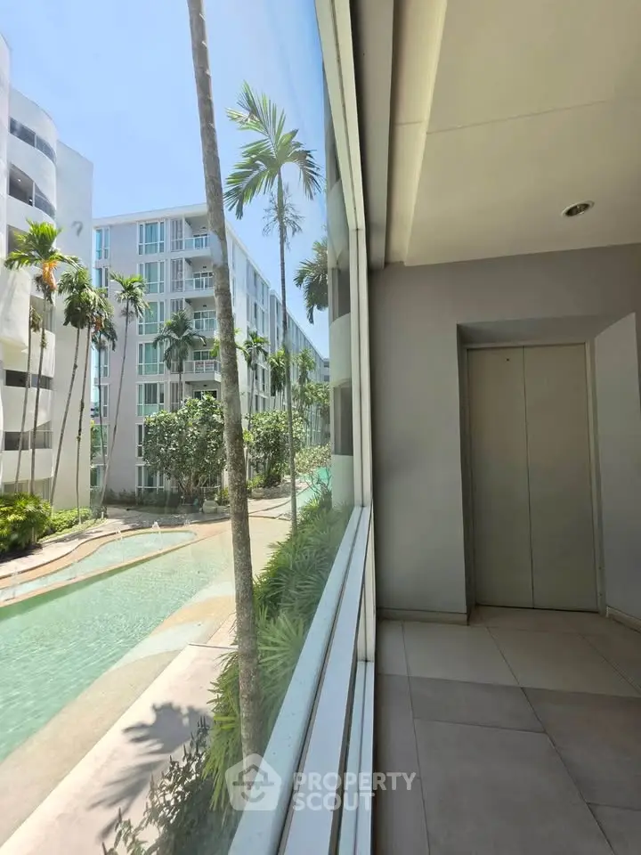 Modern apartment building with pool view from corridor window