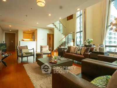 Luxurious living room with high ceilings and modern decor in a spacious apartment.