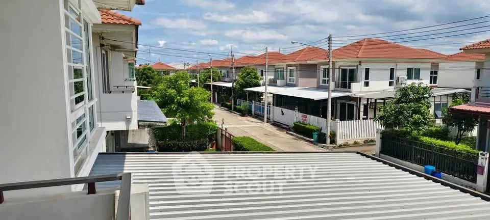 Charming suburban neighborhood with modern houses and lush greenery under a clear blue sky.