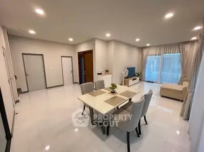 Spacious modern living room with elegant dining area and natural light