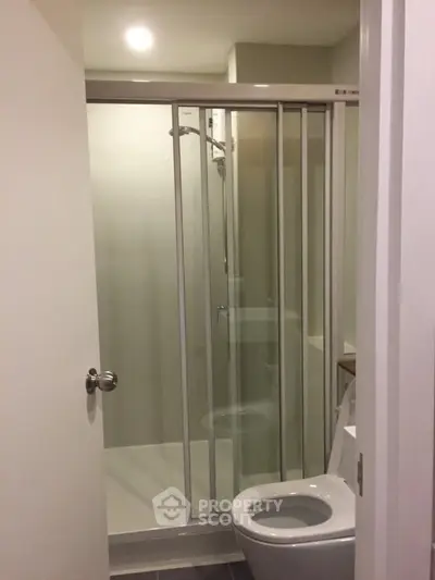 Modern bathroom with glass shower enclosure and sleek fixtures