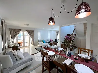Spacious open-plan living and dining area with elegant decor and natural light.