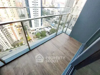 Modern high-rise balcony with stunning city view and glass railing.