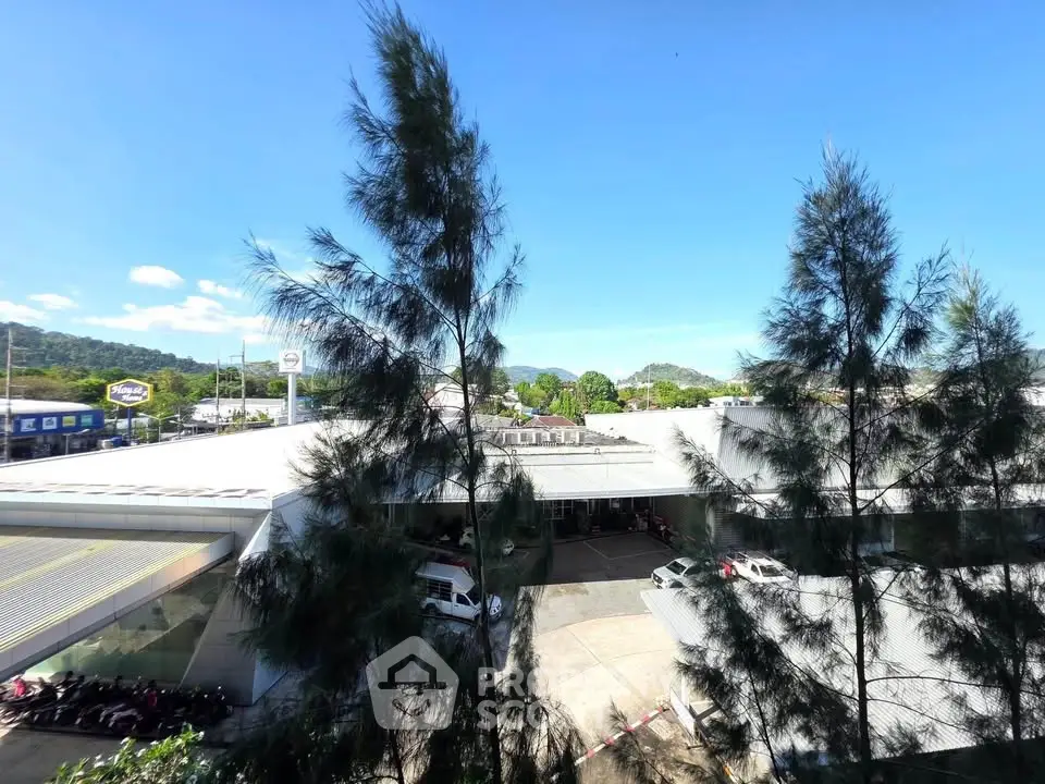 Expansive commercial building with ample parking and scenic views