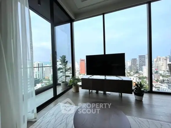 Luxurious living room with floor-to-ceiling windows offering stunning city views and modern decor.