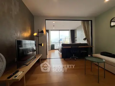 Modern open-plan living room with stylish decor and city view