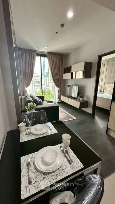 Modern living room with elegant decor and open view to bedroom