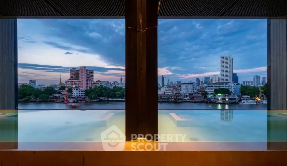 Stunning rooftop infinity pool with breathtaking city skyline view at sunset.
