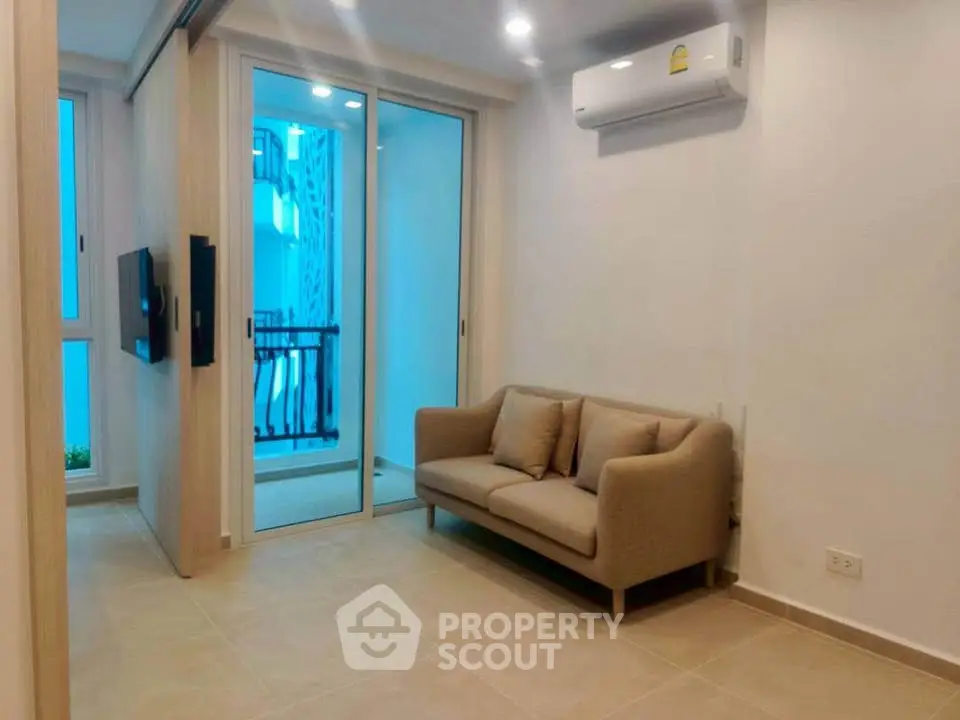 Modern living room with cozy sofa and balcony view in a stylish apartment.