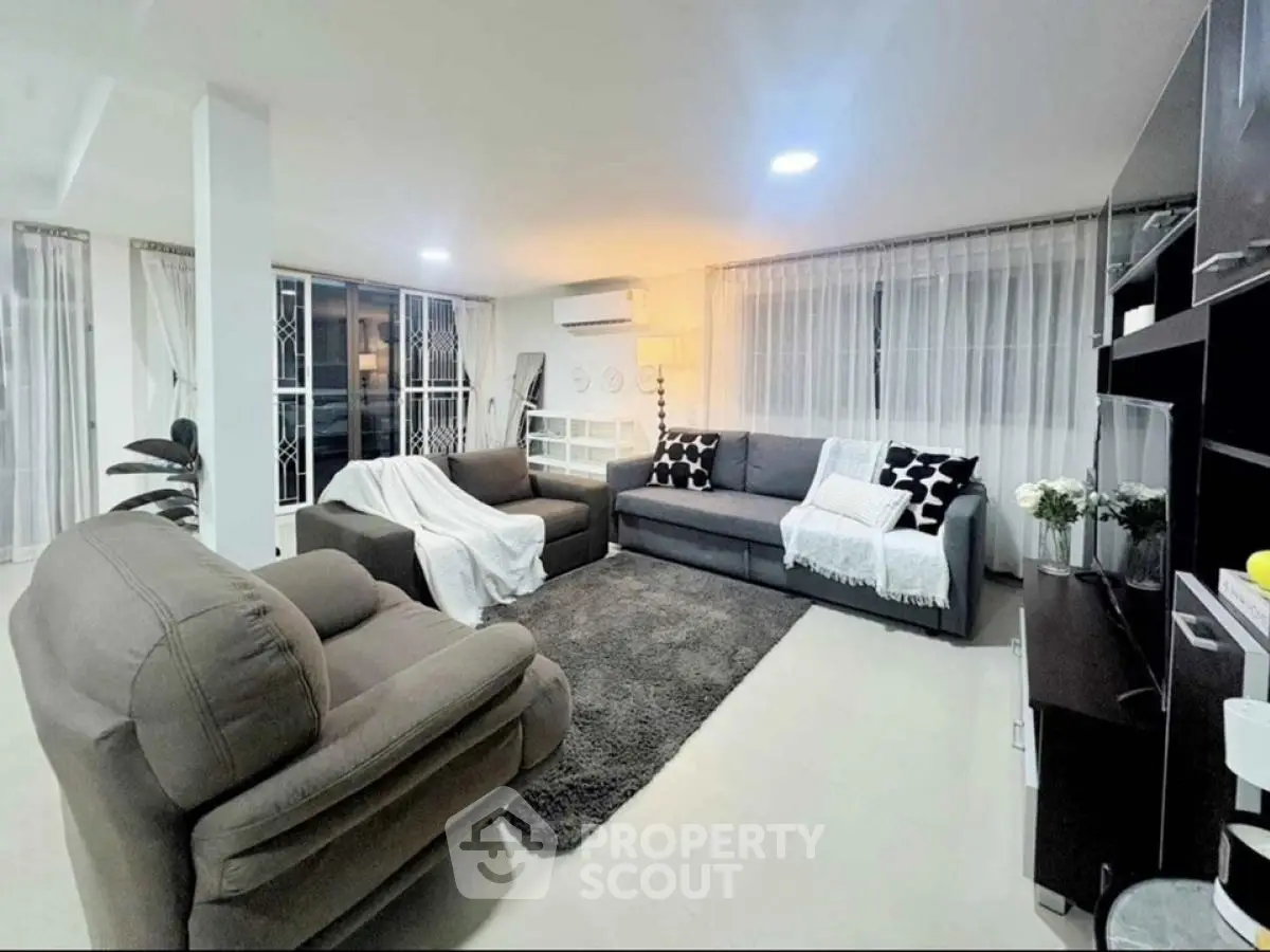 Spacious modern living room with cozy seating and elegant decor