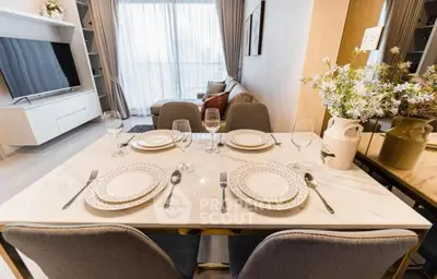 Elegant dining area with modern table setting in a stylish living room.
