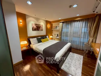 Luxurious bedroom with modern decor and ambient lighting in a stylish apartment.
