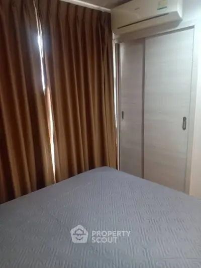 Cozy bedroom with air conditioning and sliding closet doors, perfect for comfortable living.