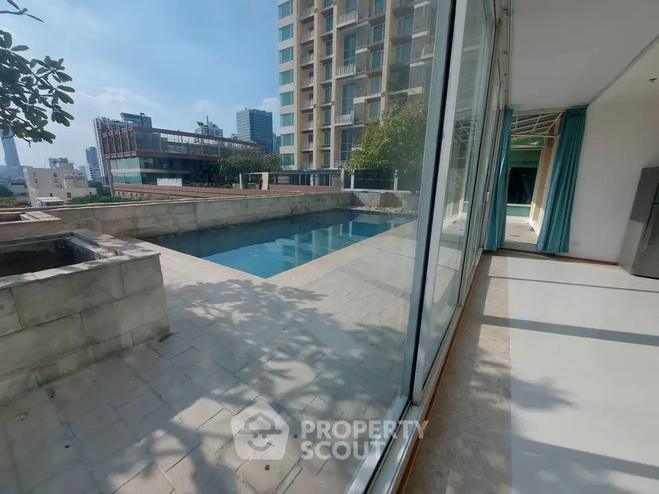 Luxurious rooftop pool with city view in modern apartment complex