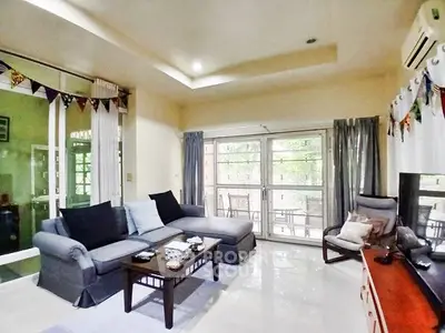 Spacious living room with modern decor and large windows for natural light.