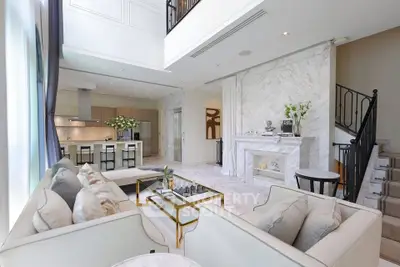 Luxurious open-plan living room with elegant decor and modern kitchen