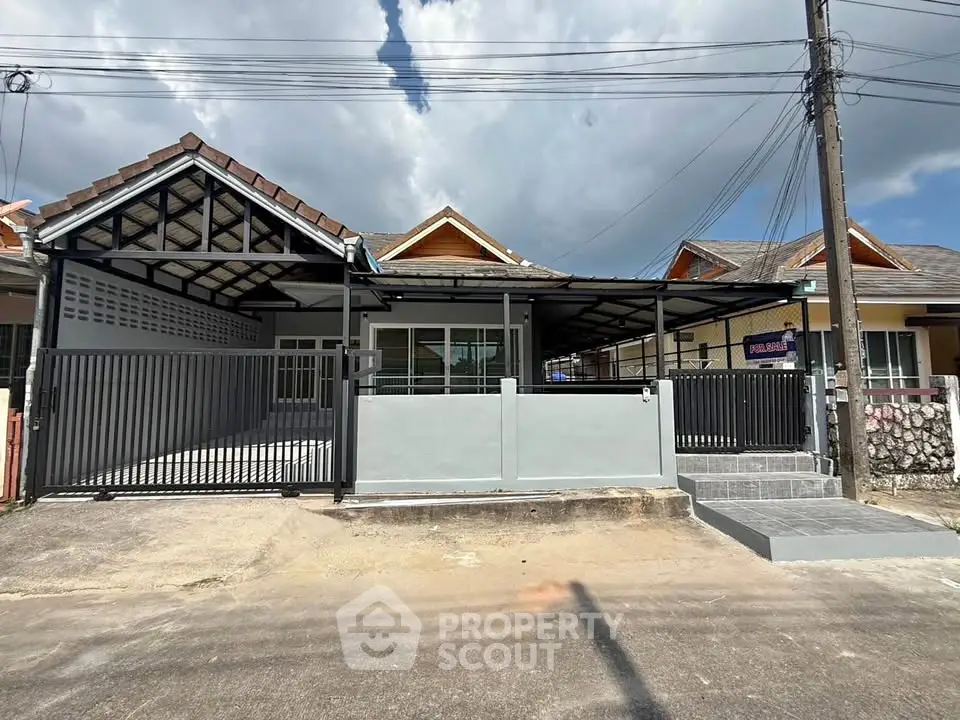 Charming single-story home with modern facade and spacious driveway in a serene neighborhood.