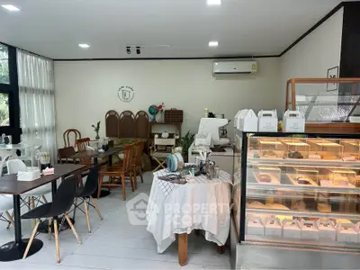 Charming cafe interior with cozy seating and dessert display, perfect for a relaxing coffee break.