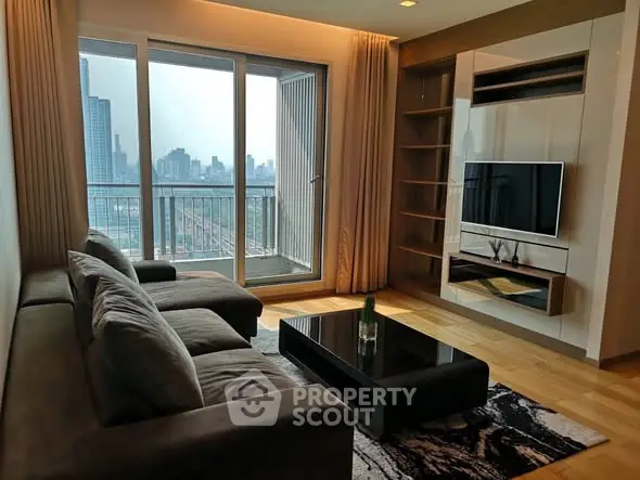 Modern living room with city view, sleek furniture, and large windows in a high-rise apartment.