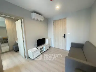 Modern living room with sleek furniture and air conditioning in a cozy apartment.