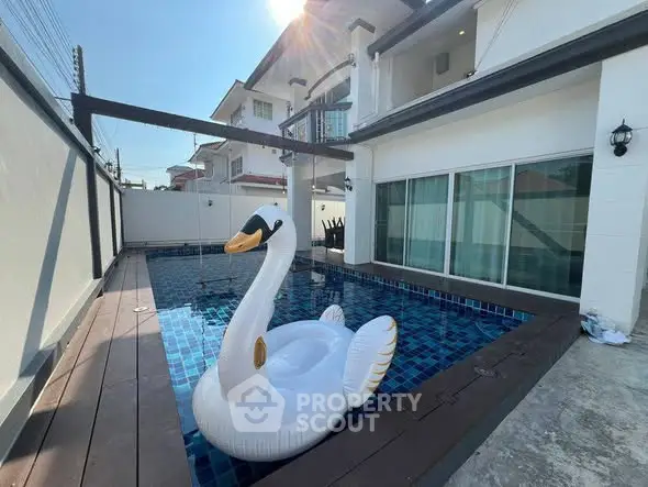 Luxurious home with private pool and stylish swan float, perfect for relaxation and entertainment.