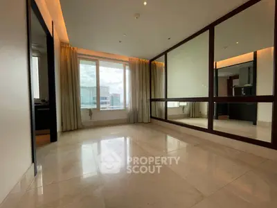 Spacious modern living room with large windows and marble flooring