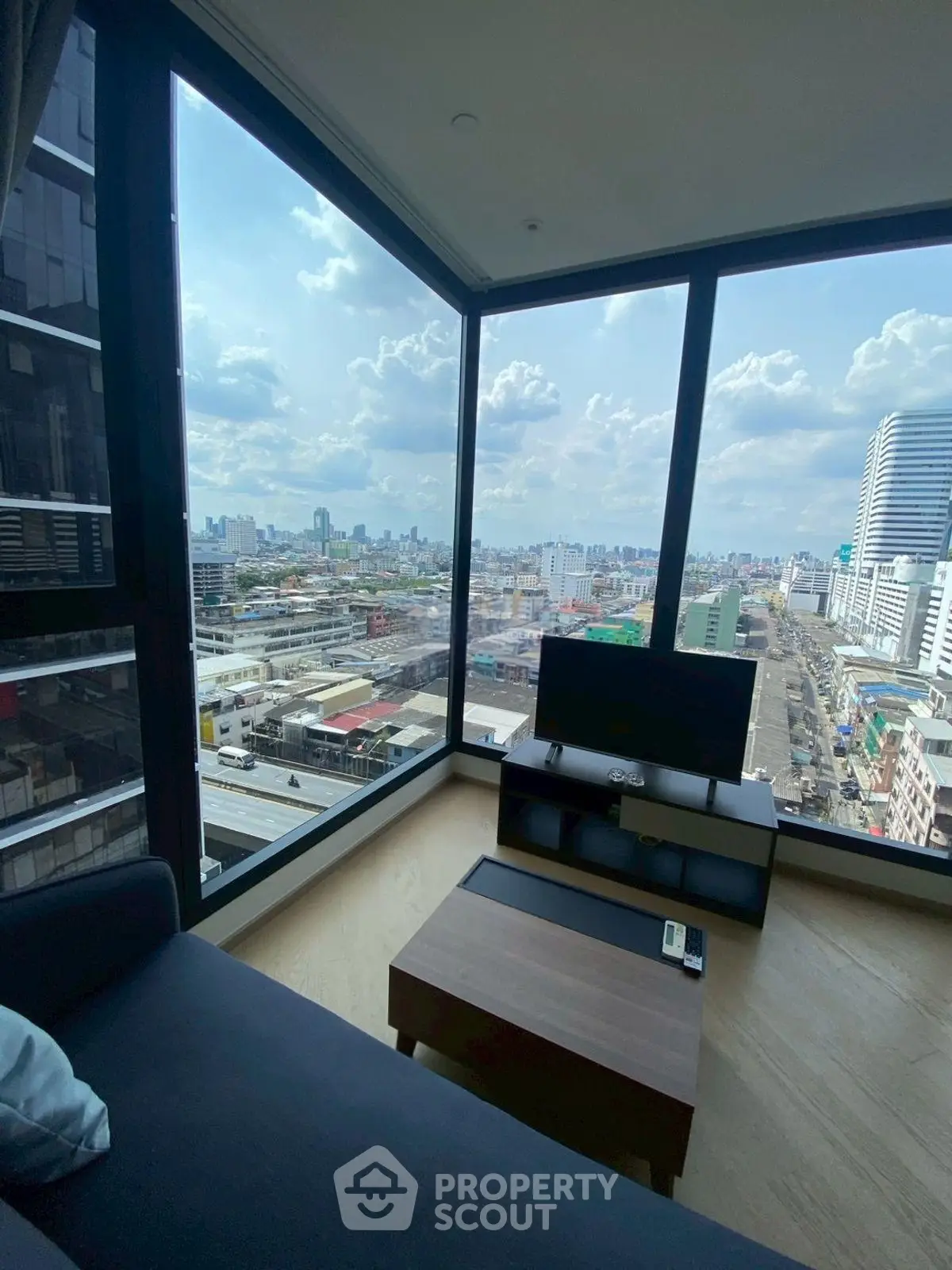 Stunning corner unit with panoramic city views from a modern living room.