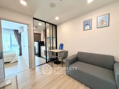 Modern apartment interior with open layout, featuring cozy living room and compact kitchen area.