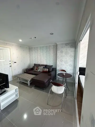 Modern living room with stylish decor and cozy seating area in a contemporary apartment.