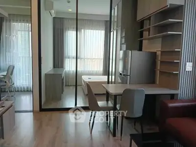 Modern studio apartment with open layout, featuring a cozy living area, dining space, and bedroom with natural light.