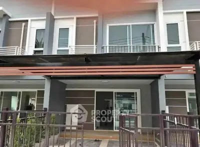 Modern townhouse exterior with sleek design and spacious balcony