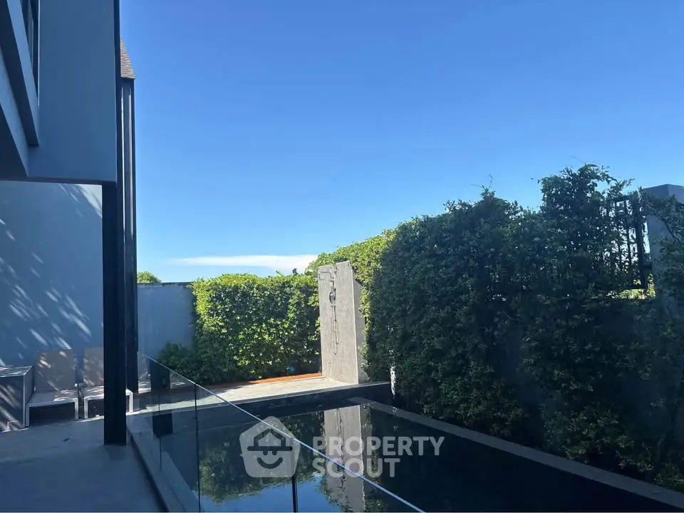 Luxurious modern home with private pool and lush greenery, perfect for relaxation and entertaining.