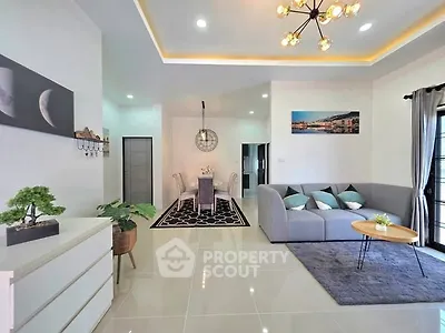 Modern living room with stylish decor and open dining area