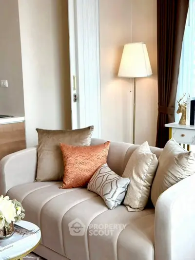 Elegant living room with stylish sofa and decorative pillows, perfect for modern comfort.