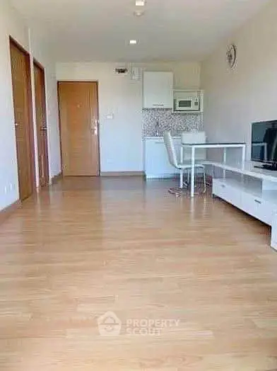 Spacious modern living room with wooden flooring and minimalist decor