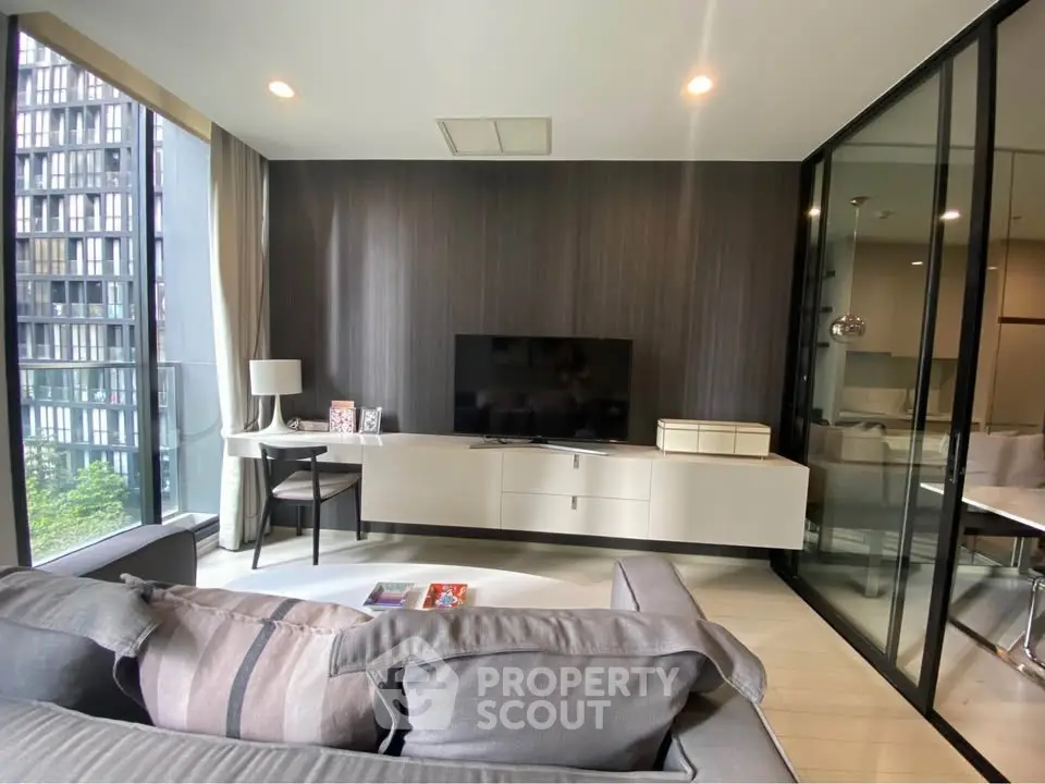 Modern living room with sleek design and large windows offering city view