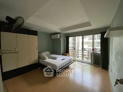 Spacious bedroom with balcony access in modern apartment